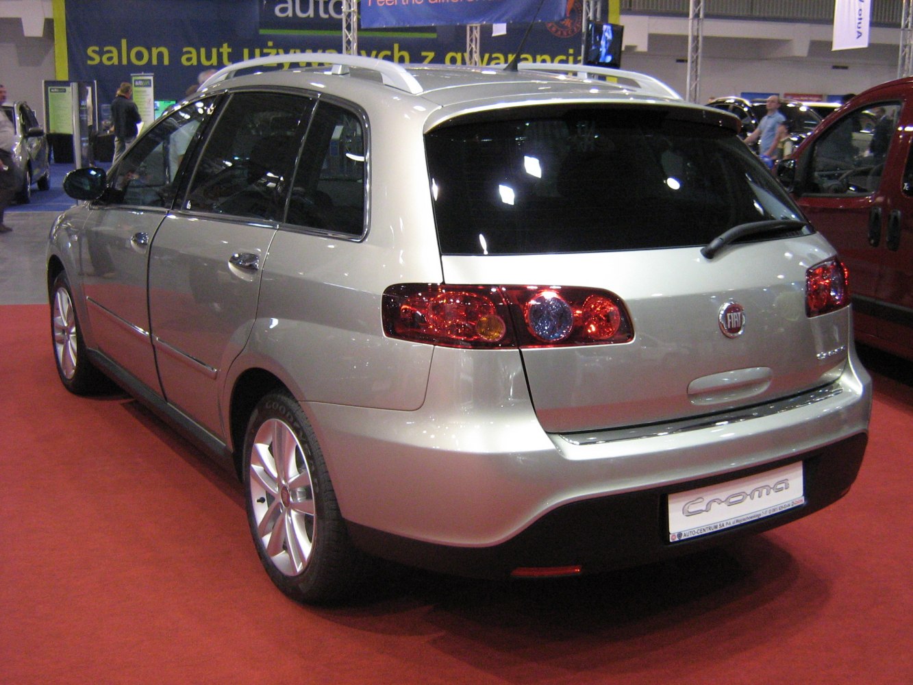 Rear view and taillights of a silver wagon with roof rails