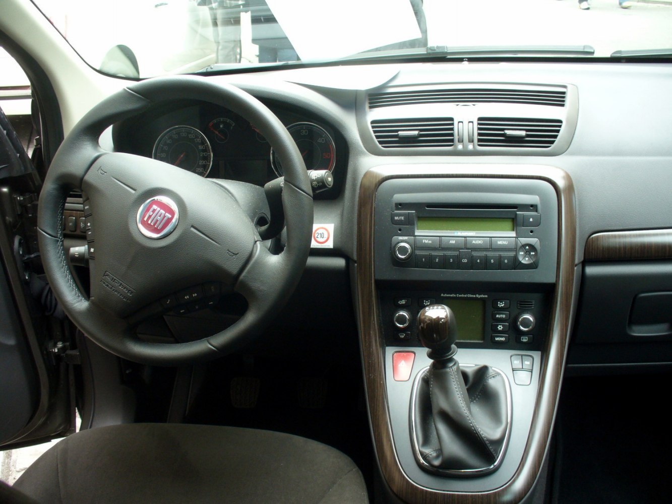 Steering wheel, dashboard, manual gear shift close-up