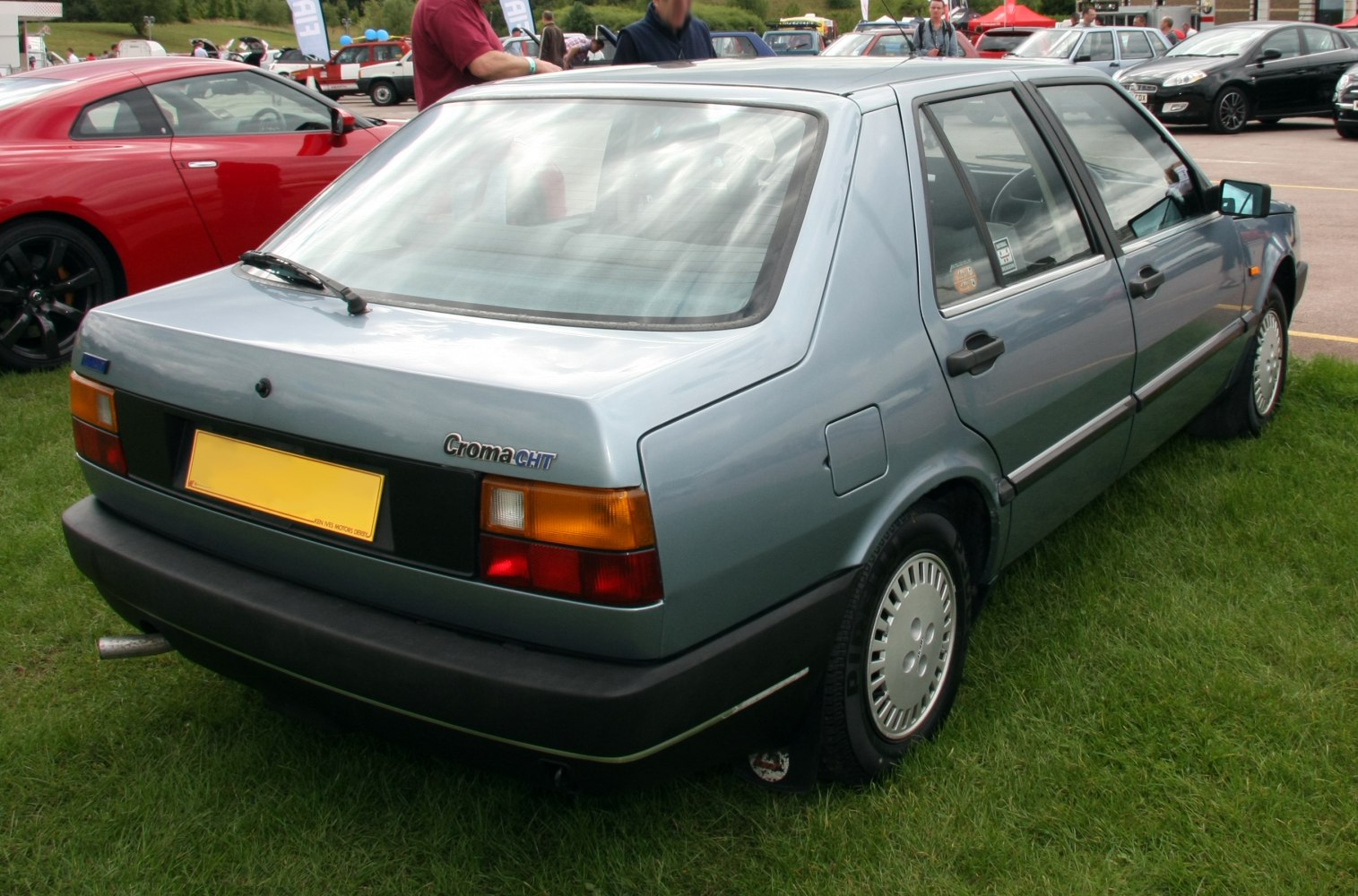Rear three-quarter view of boxy classic sedan with distinctive rear lights.