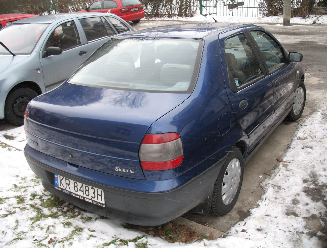 Rear sedan view with rounded tail lights and hatchback style.