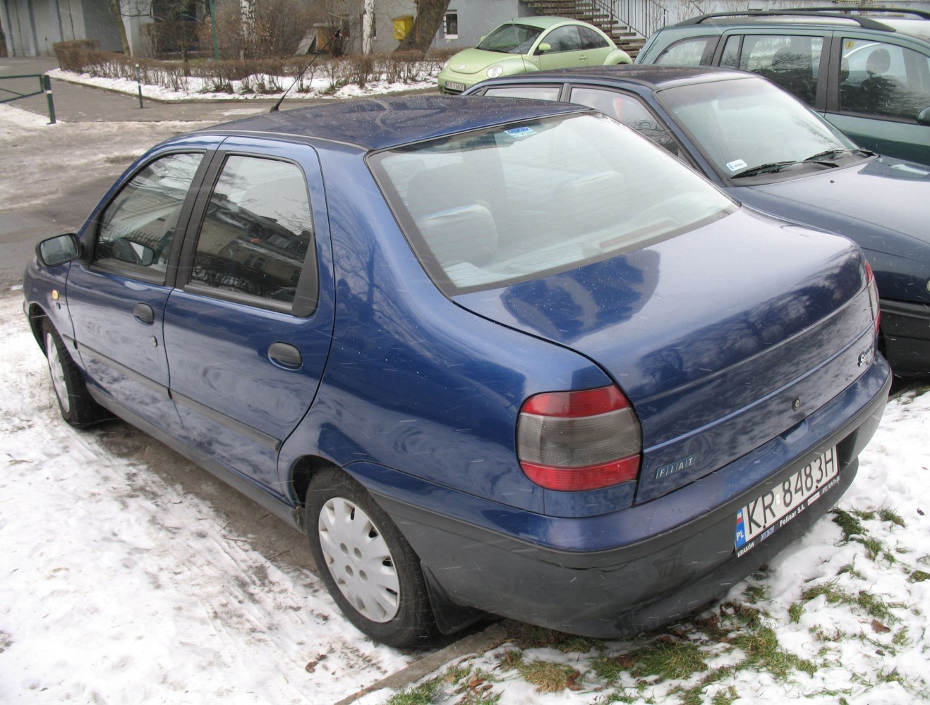Blue compact sedan rear and side view with distinctive tail lights