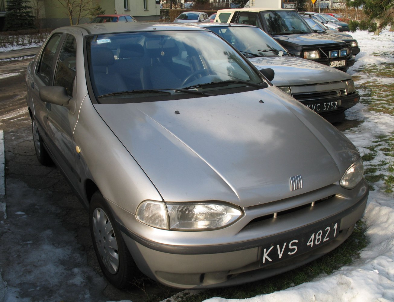 Front view of a sedan with rounded headlights and simple bumper
