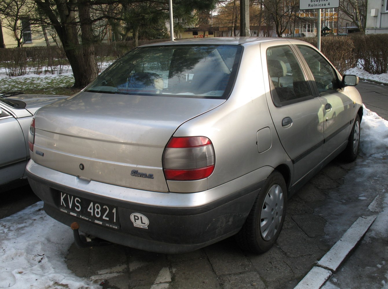 Rear view of silver compact sedan with unique taillights and rear bumper.
