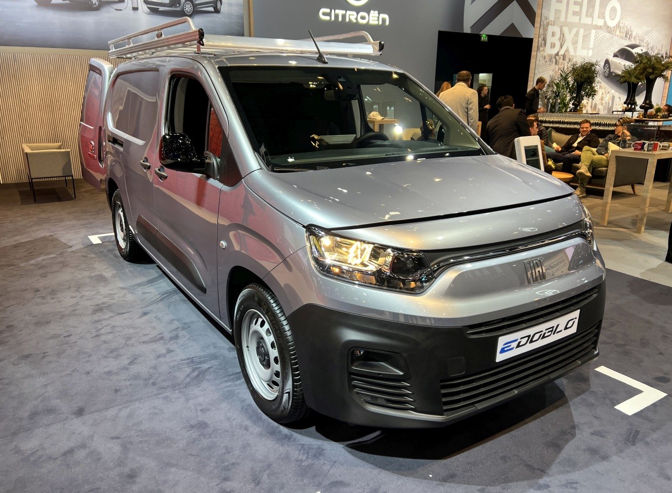 Silver commercial van with roof rack and modern front design