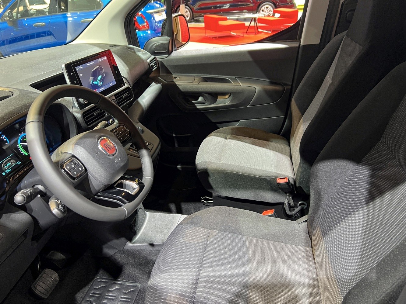 Modern car interior with digital dashboard and fabric front seats