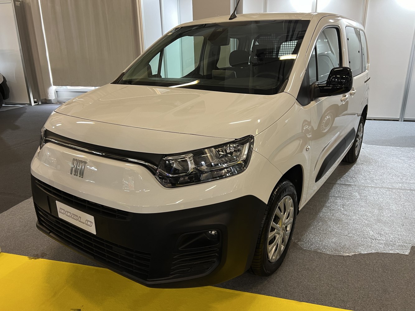 Front-side view of compact commercial van with LED headlights and practical body design.
