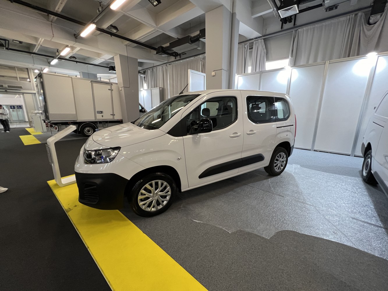White commercial van, front side profile, indoor exhibition