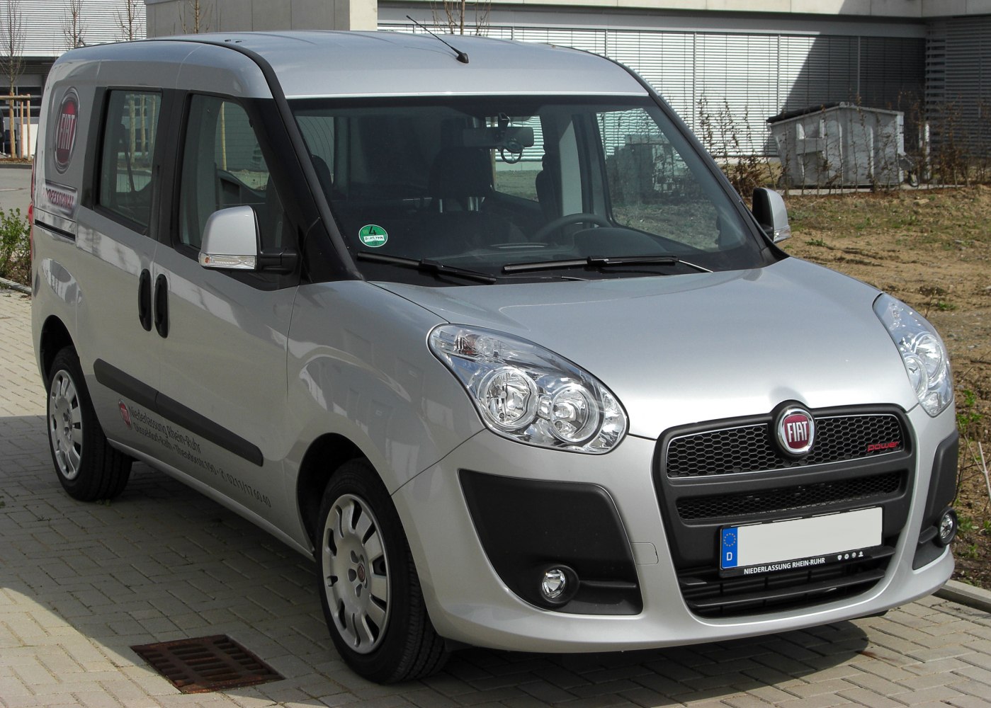 Front grille and headlights of a silver compact van