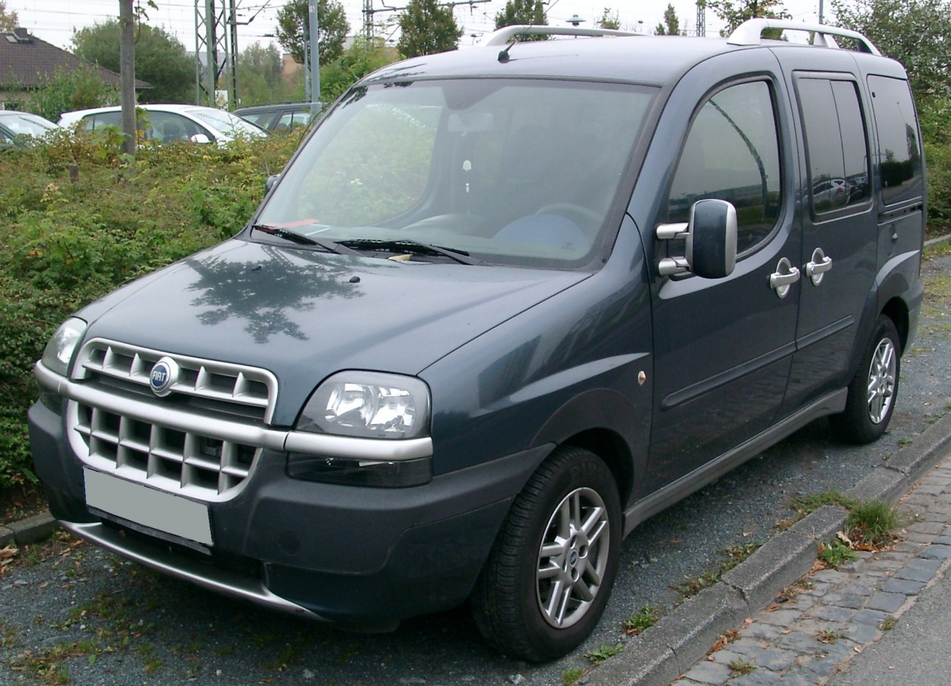 Front and side view of dark blue compact van with alloy wheels