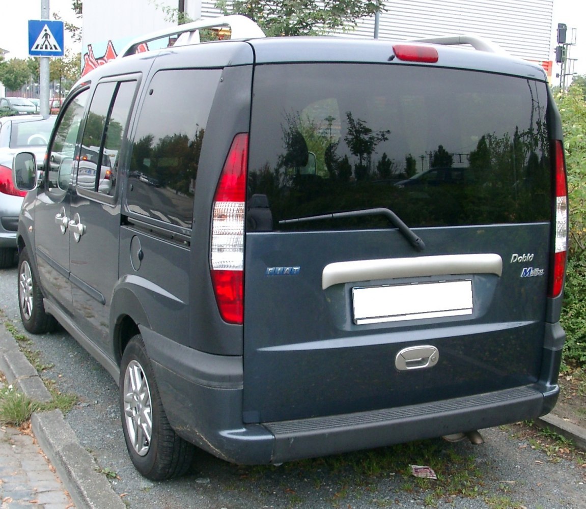 Rear view with tall vertical tail lights and rear window wiper on compact van