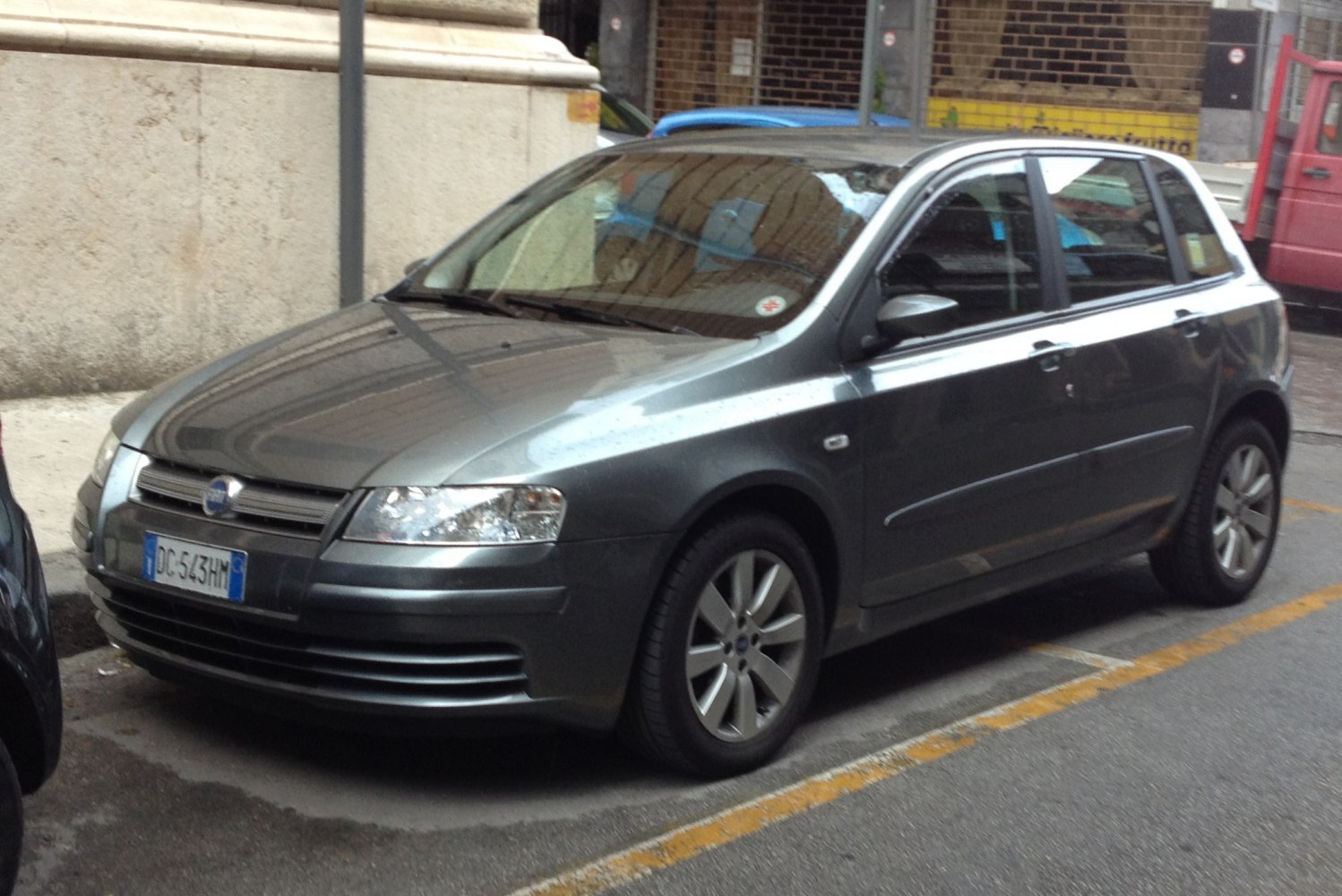 Front-side view of 5-door hatchback with distinctive grille and headlights