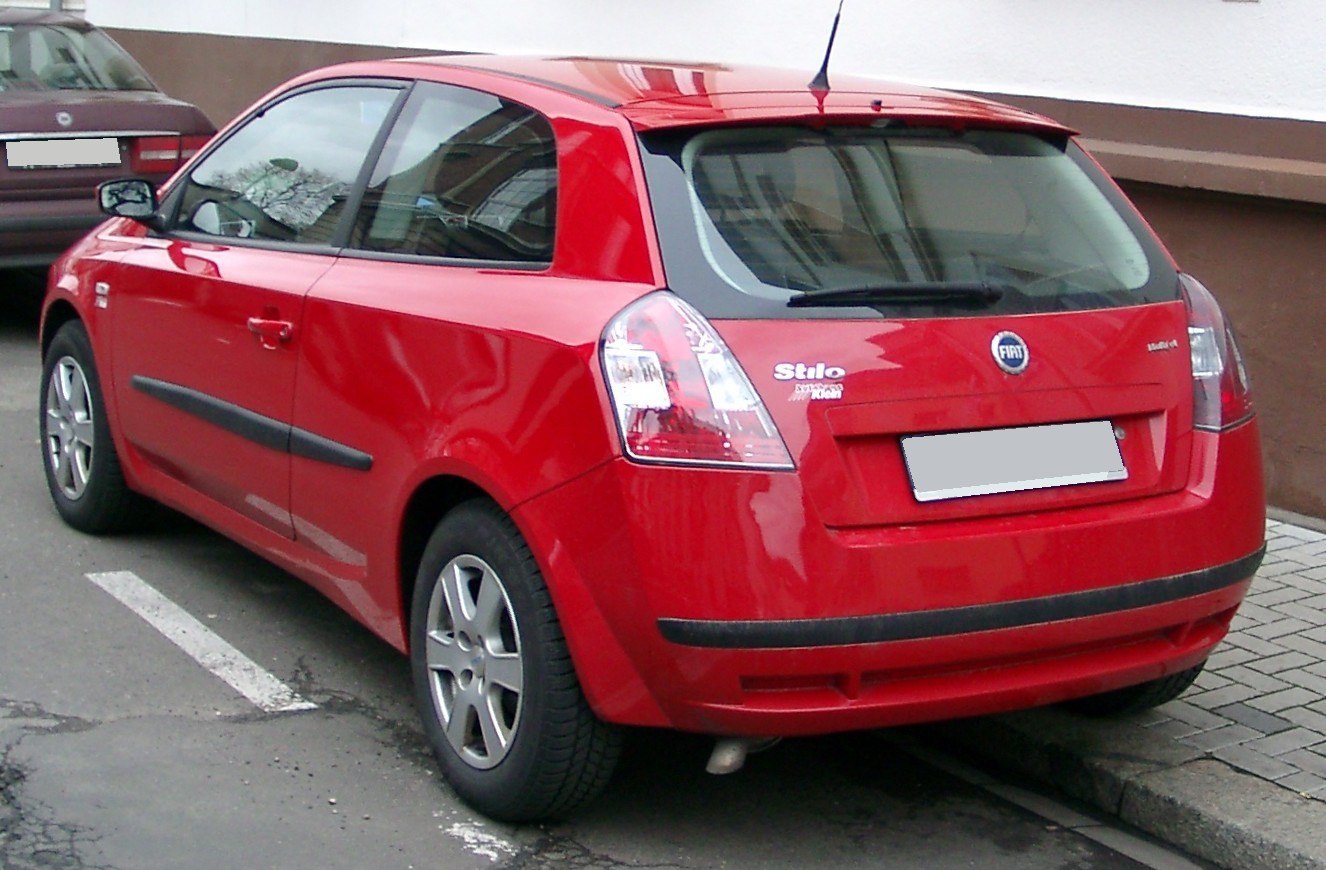 Red 3-door hatchback rear side view with facelift clear tail lights