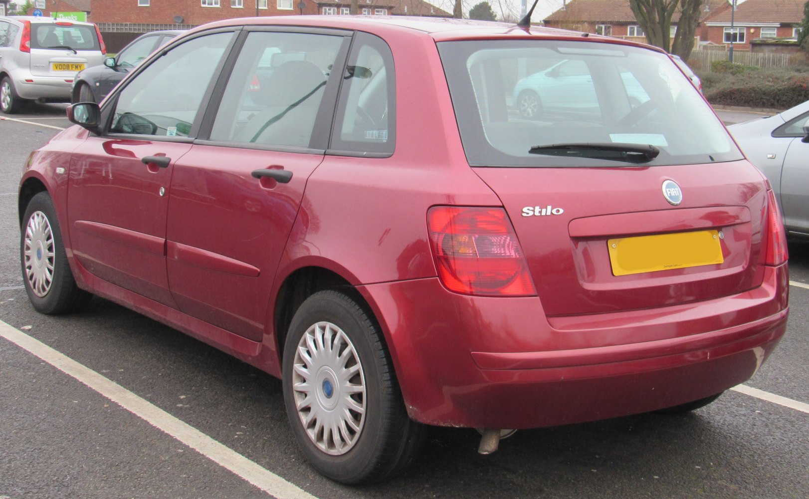 Red 5-door hatchback rear and side profile with wheel and taillight details