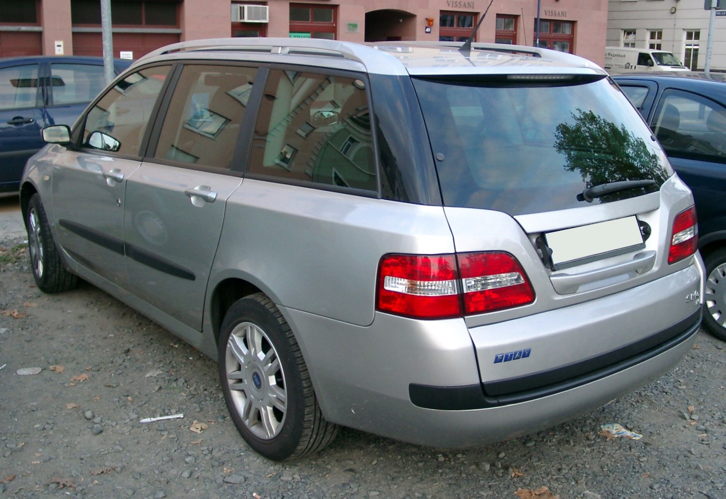 Rear and side view of a silver wagon with roof rails and distinct taillights