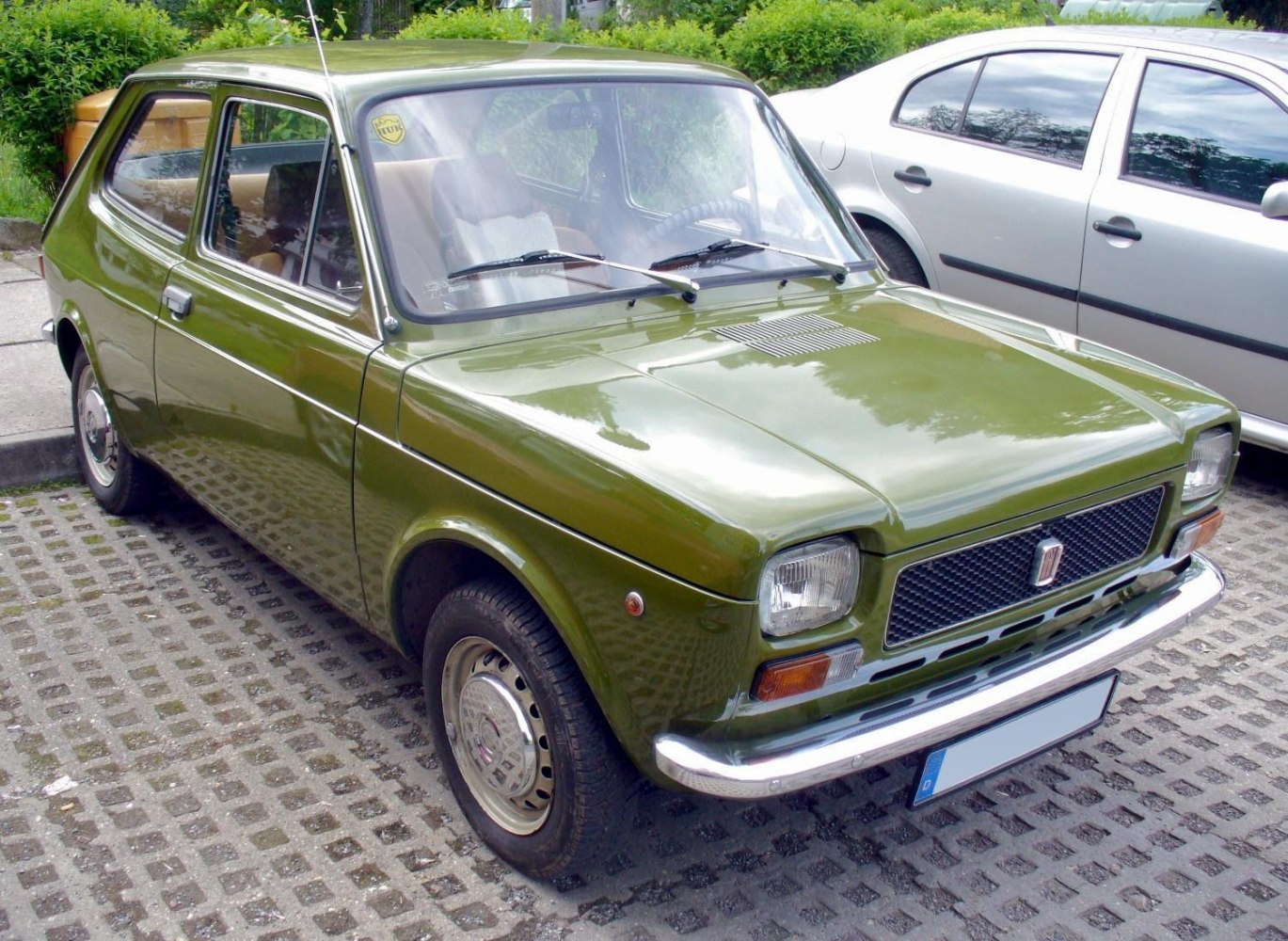 Compact hatchback with rectangular headlights, chrome bumper, and classic vintage design