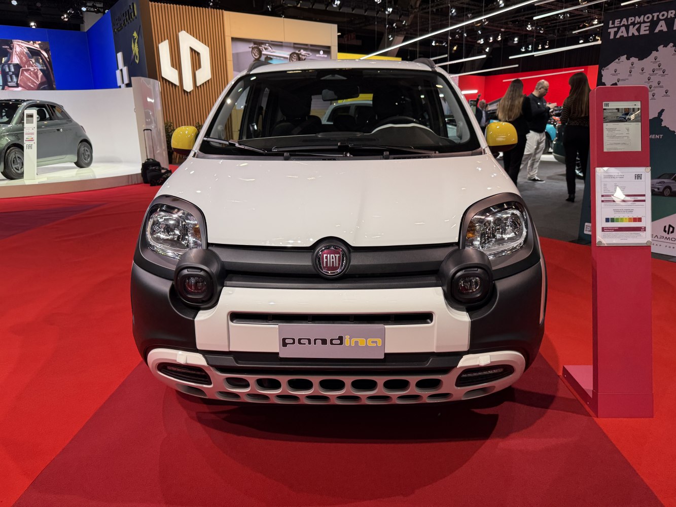 Front view with distinctive headlight guards and perforated lower grille design