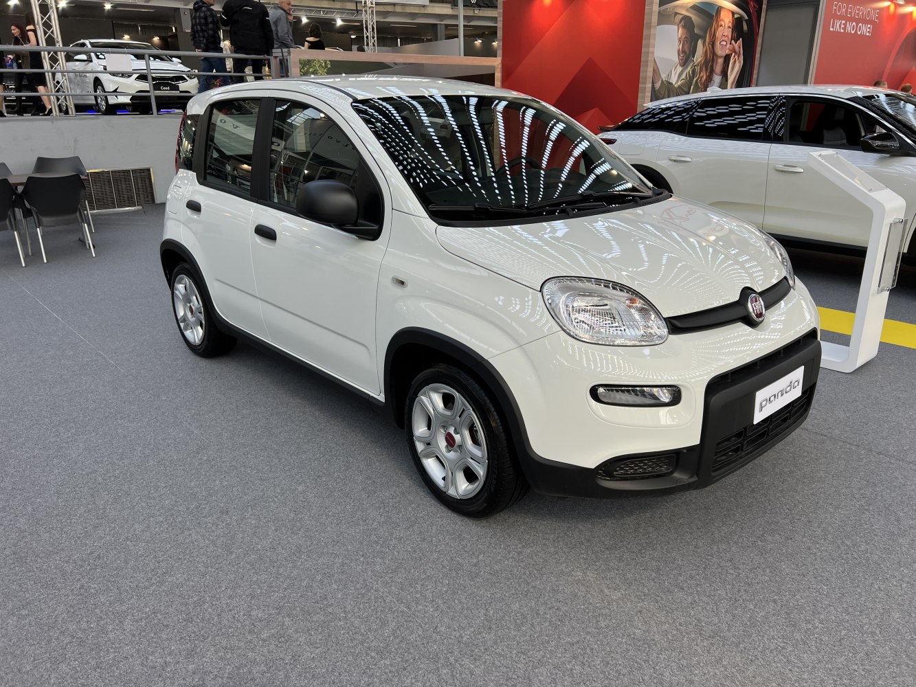 Front-left view of compact city hatchback with updated headlights and black trim