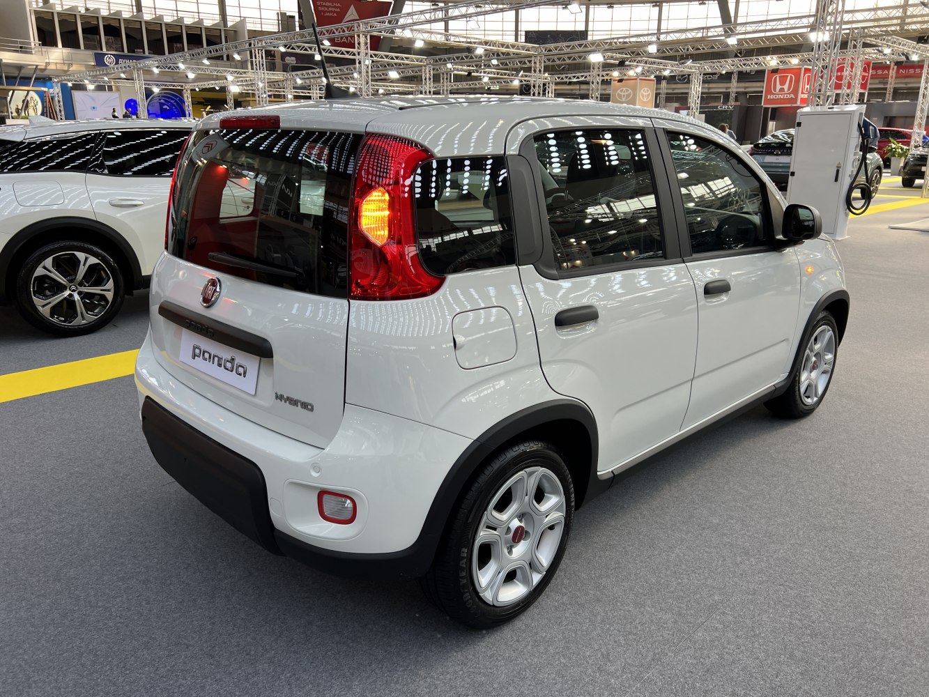 Rear view of compact white hybrid car with distinctive taillights