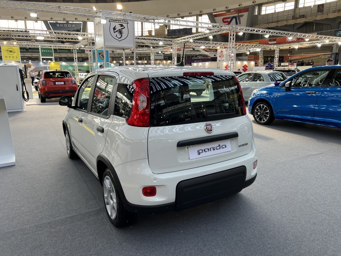 Compact five-door hatchback rear view with vertical rear lights and hybrid badge