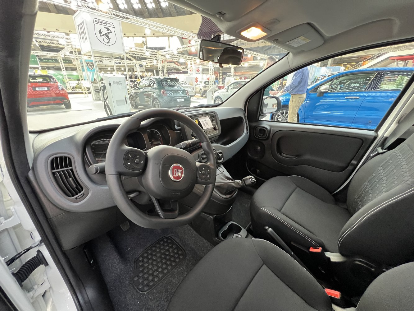 Interior view of dashboard and steering wheel with front seats