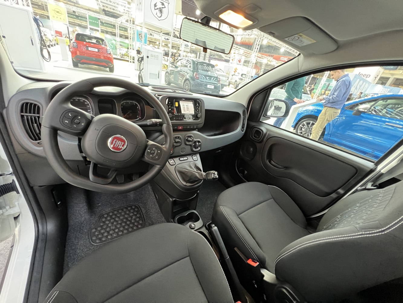 Steering wheel, dashboard, and manual gear shift of compact car interior