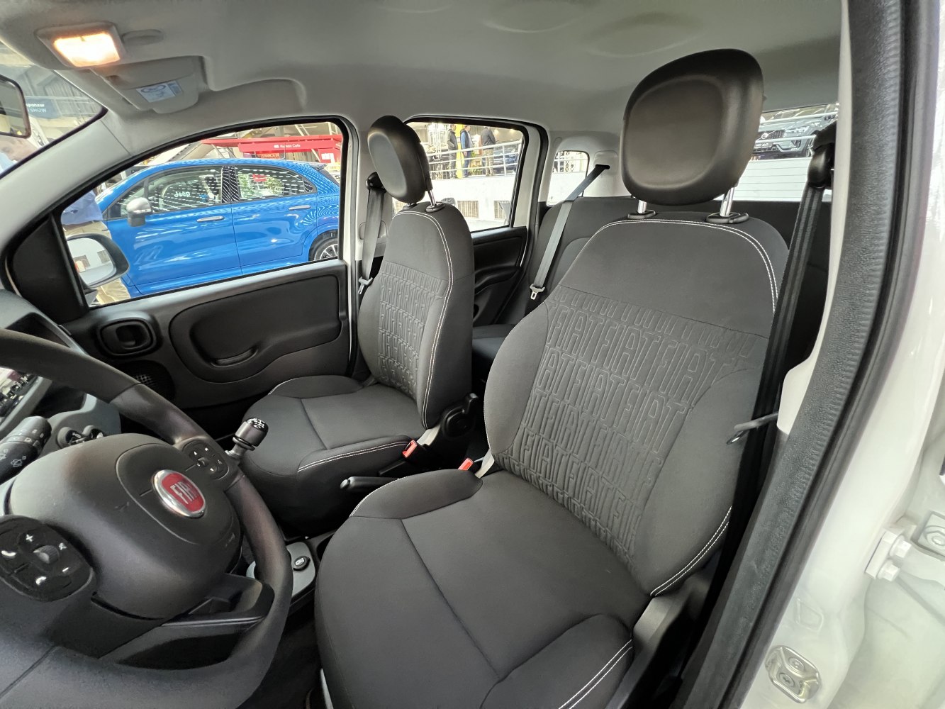 Close-up of front seats and steering wheel with patterned upholstery