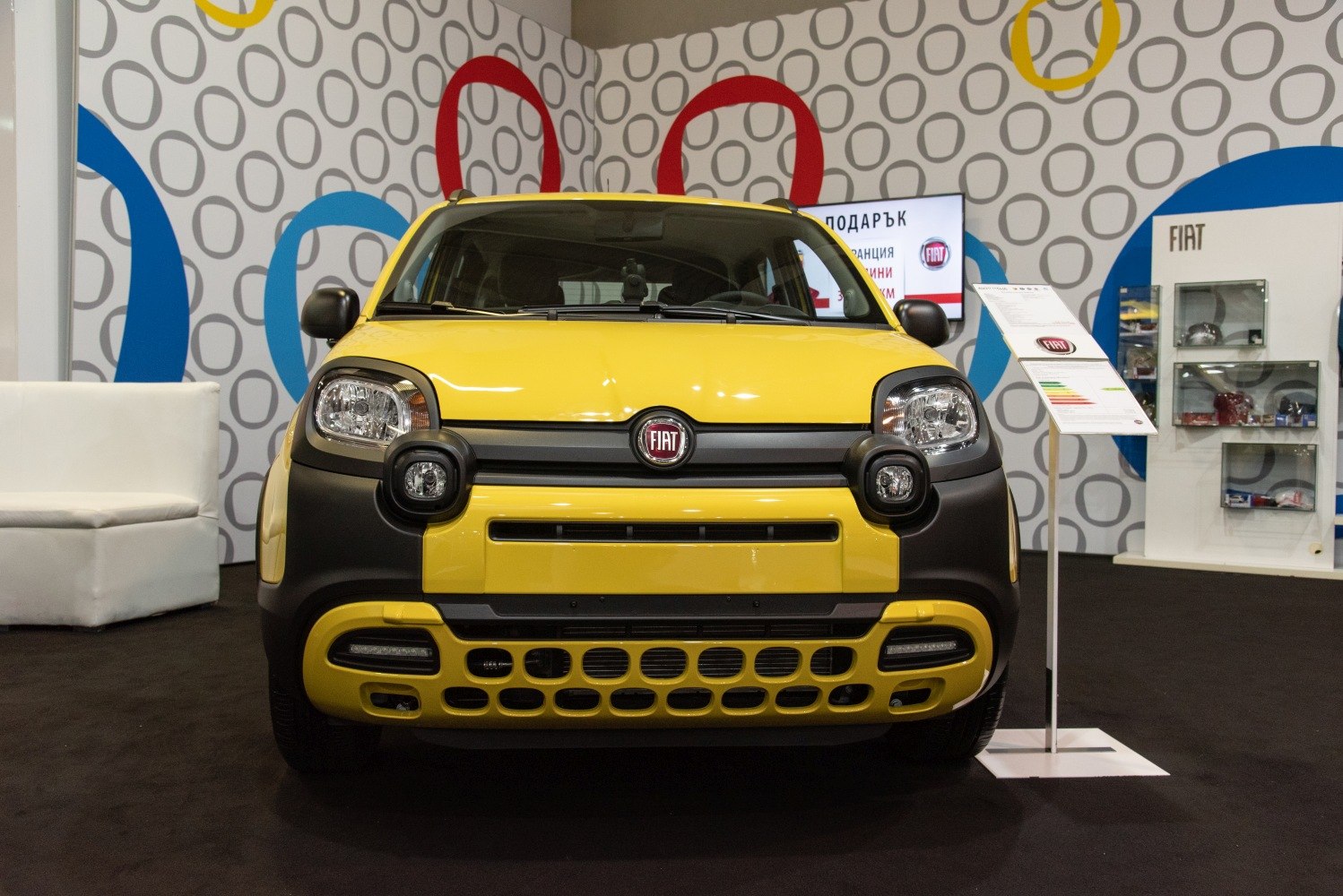 Yellow compact crossover front with round headlights and distinctive grille