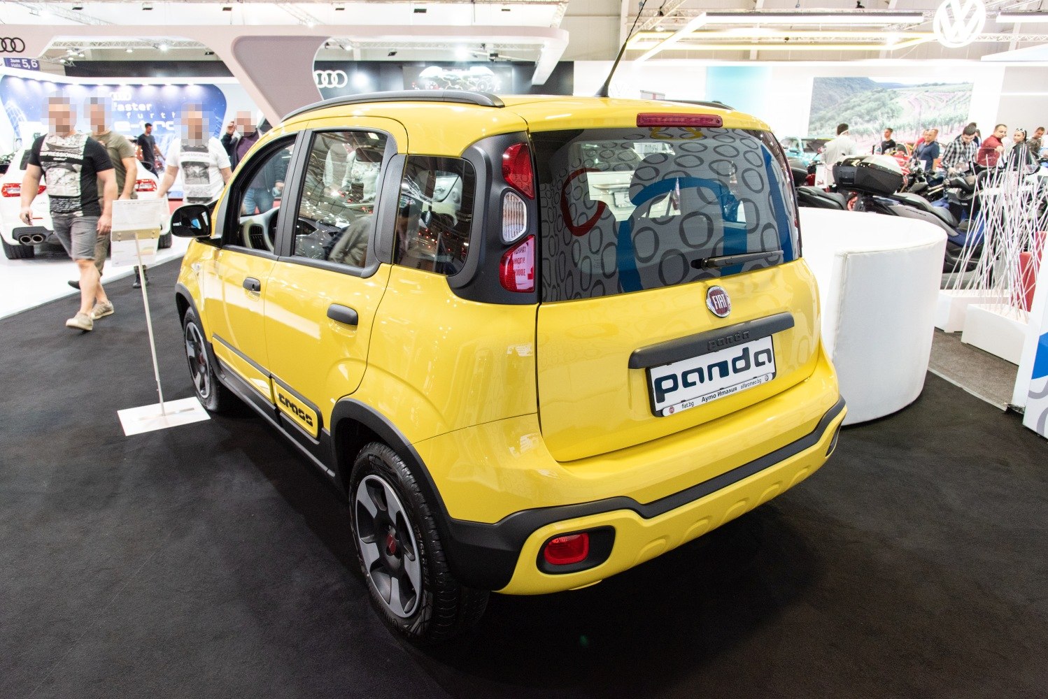 Yellow compact crossover rear side with black trim and Cross branding