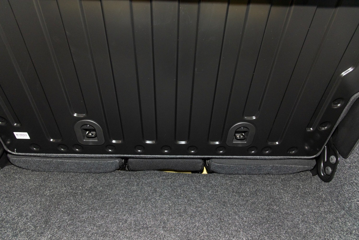Rear seatback latches and carpeted trunk floor