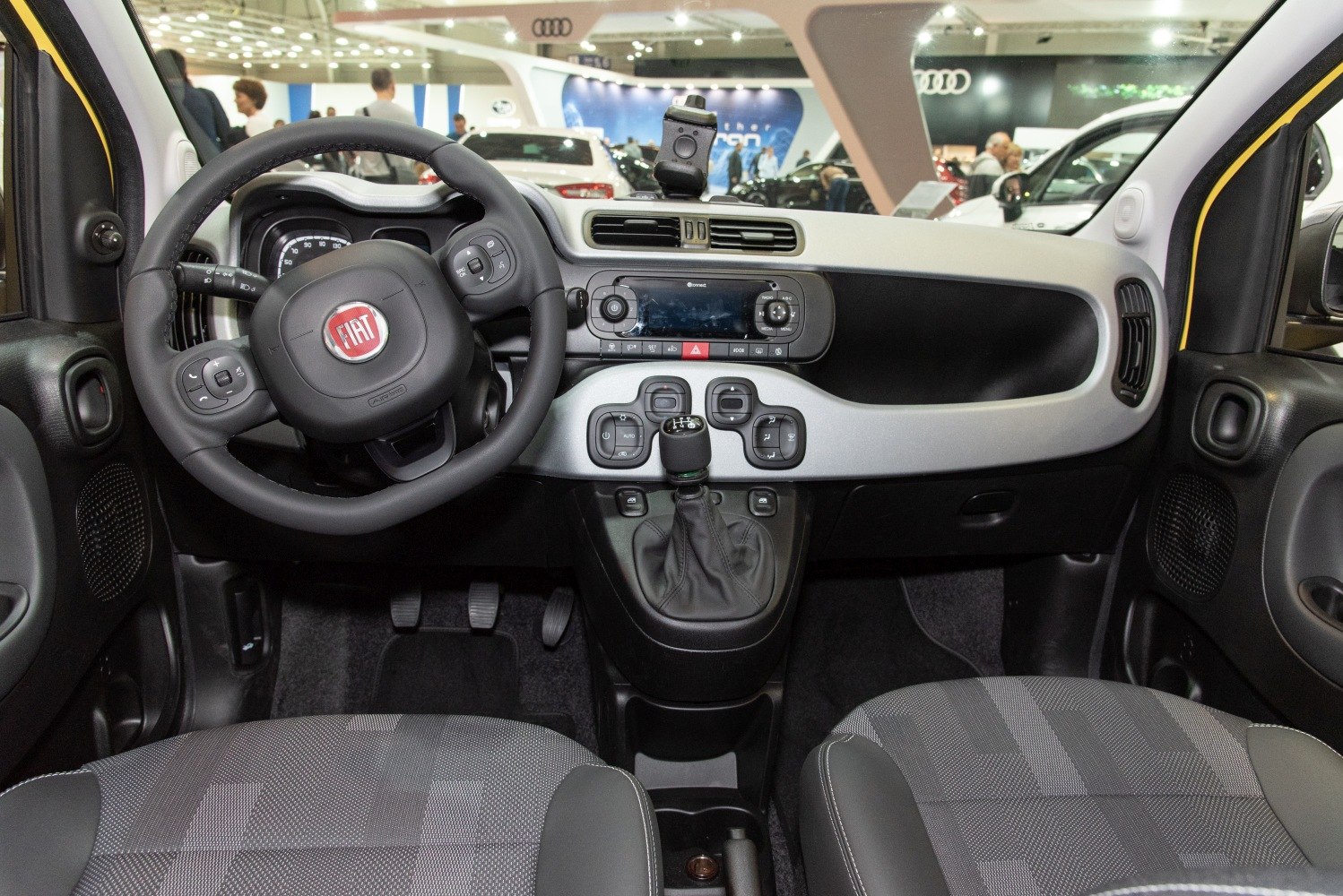 Dashboard, steering wheel, and gear shifter in compact car interior