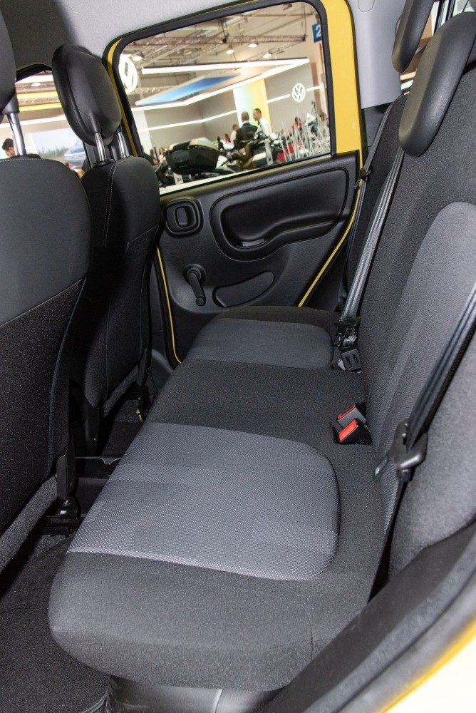 Rear seat interior with fabric upholstery and manual window crank.