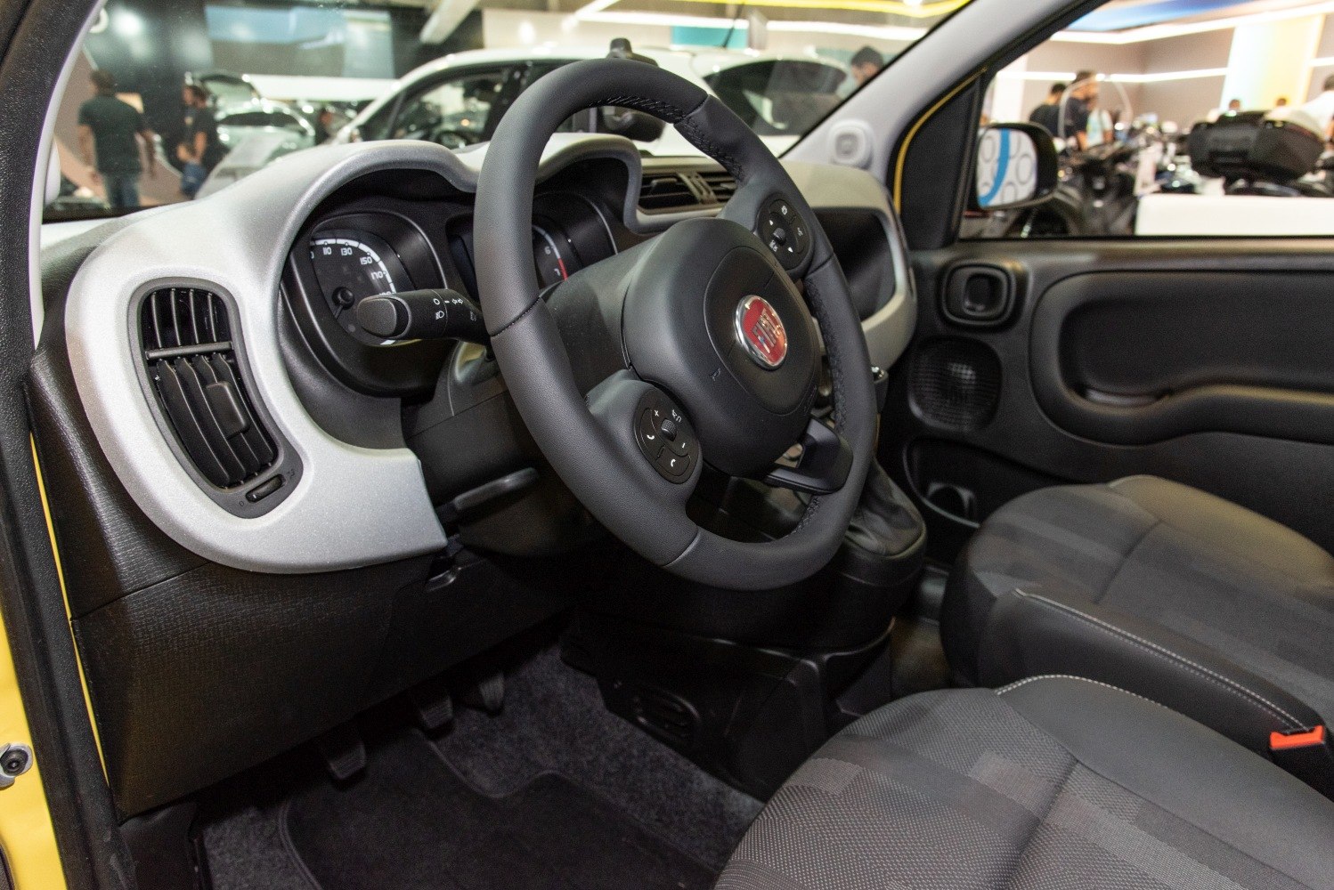 Steering wheel and dashboard with instrument cluster in compact car interior