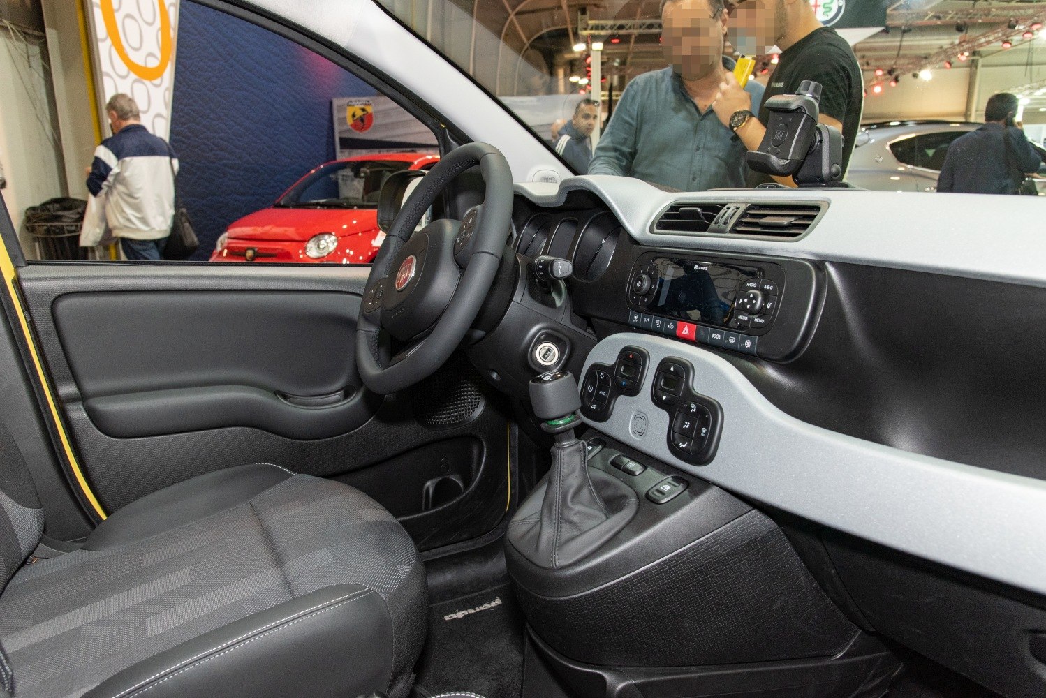 Compact urban car interior with dashboard, steering wheel, and gear shift