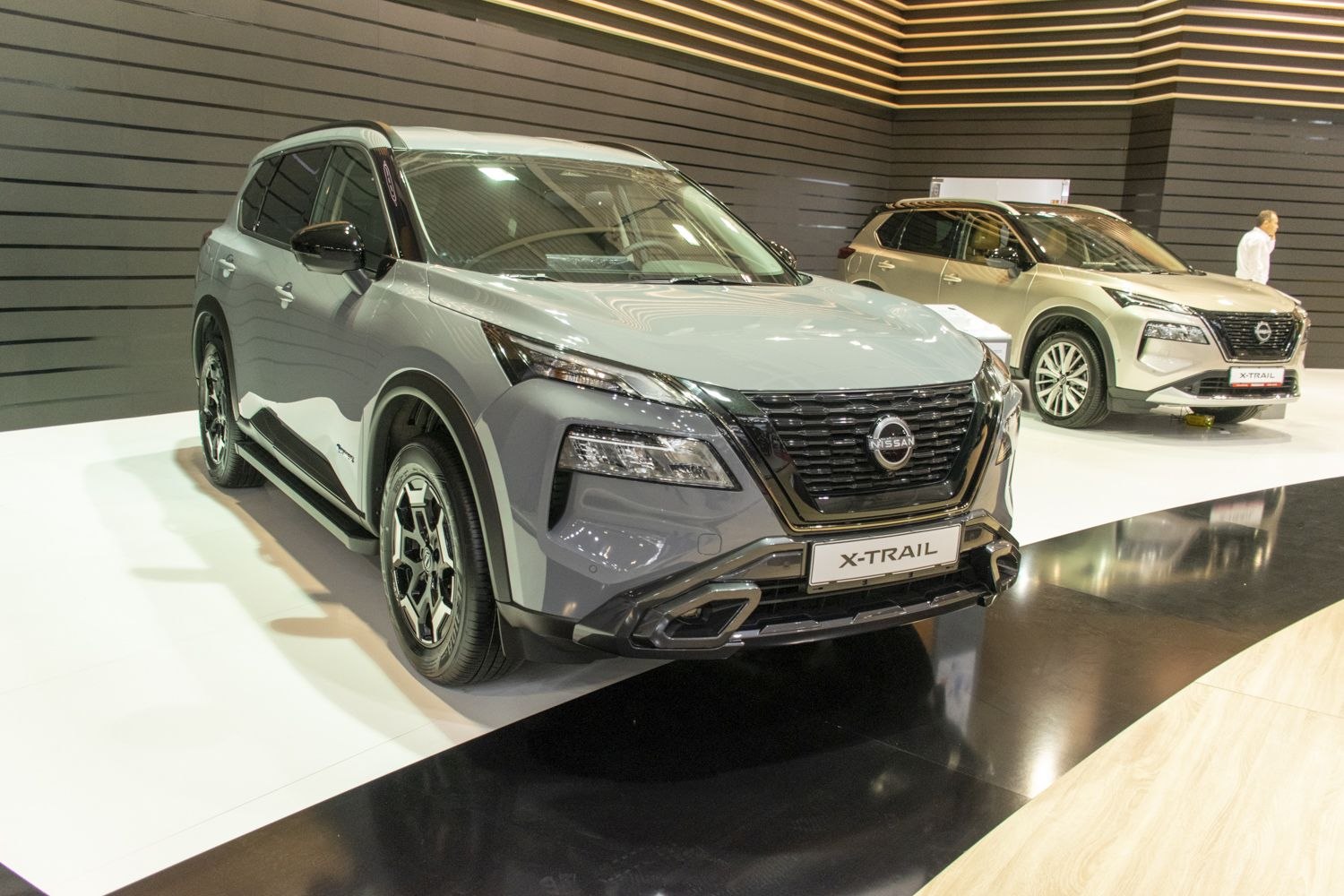 Modern SUV with prominent grille and LED headlights, showing front and side views.