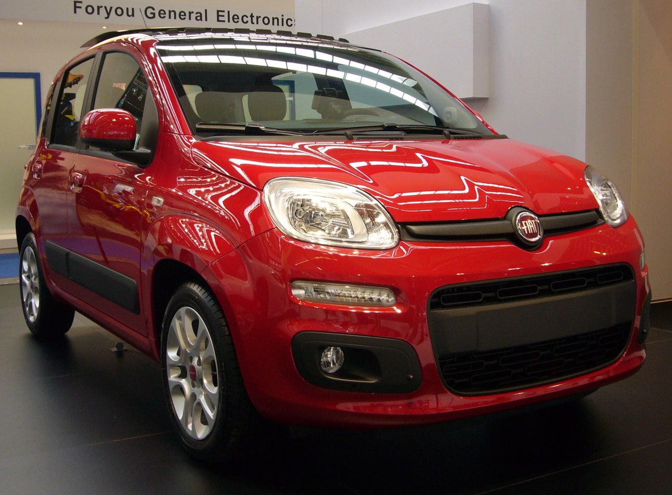 Compact city car with rounded headlights and black grille