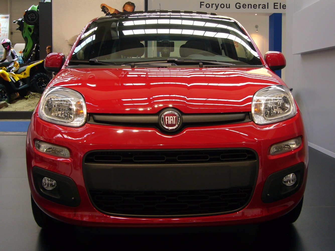 Front view with headlights and grille of red compact car