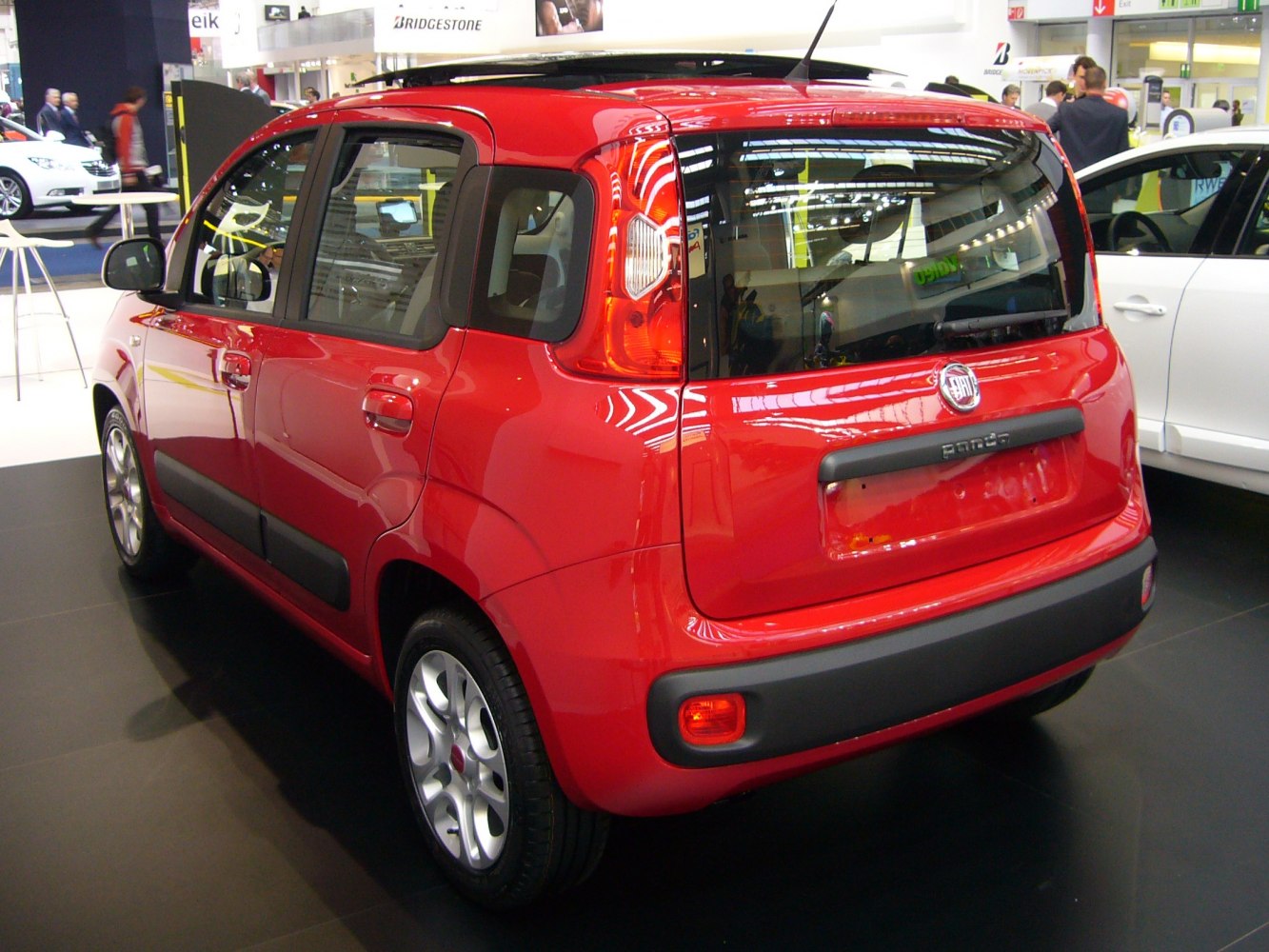 Rear view of red compact hatchback with vertical taillights and five doors