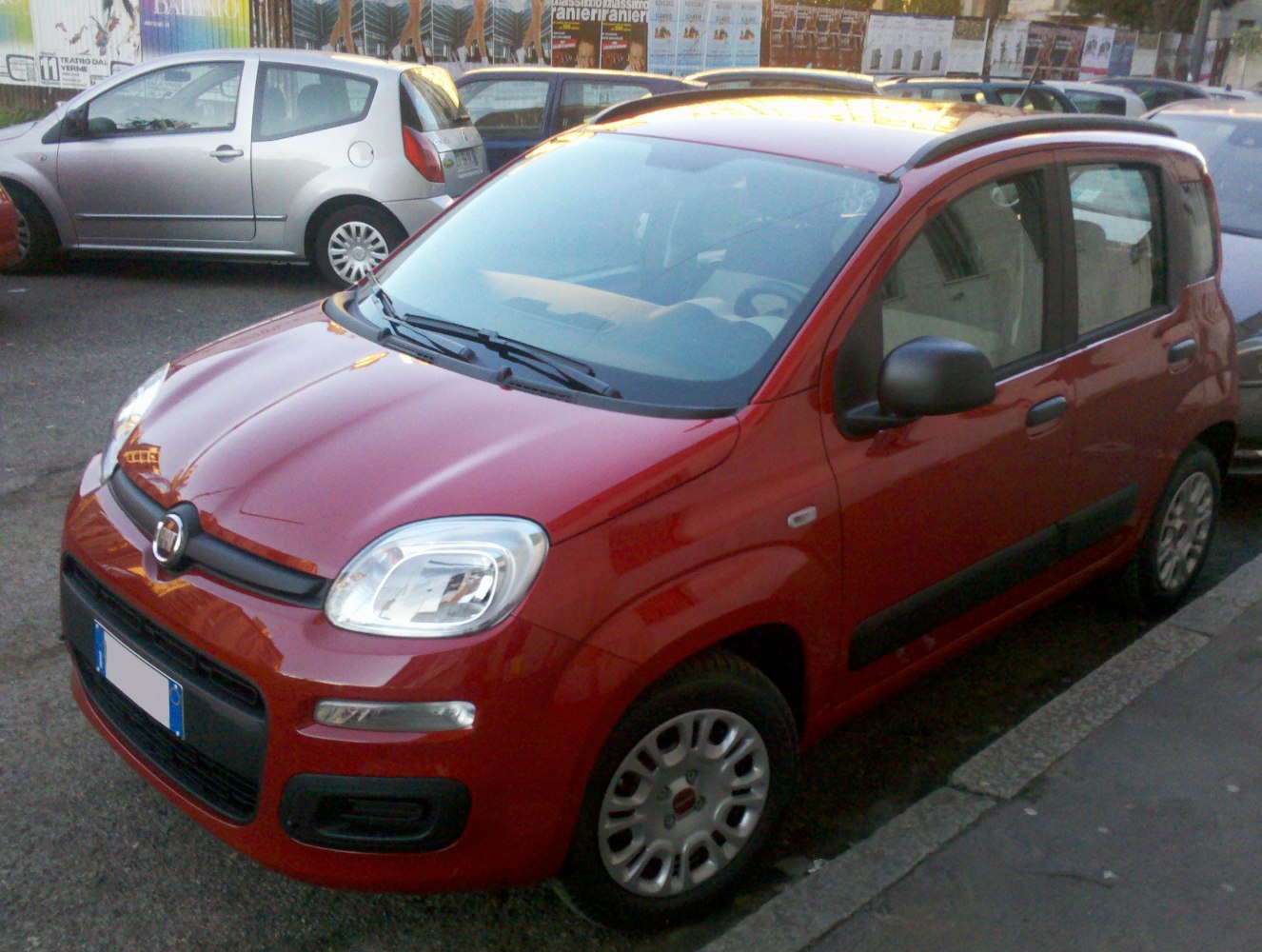Compact hatchback front side view in red