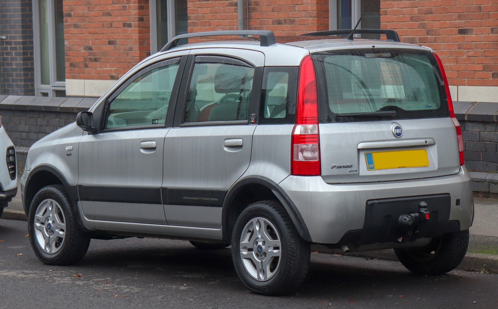 Silver compact hatchback rear side with roof rails and taillights