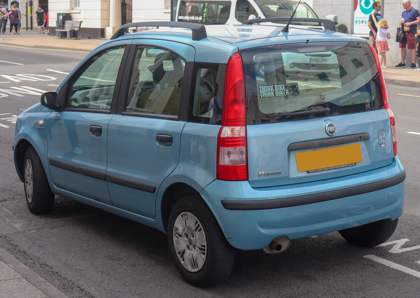Rear and side view of a compact hatchback with tall vertical taillights