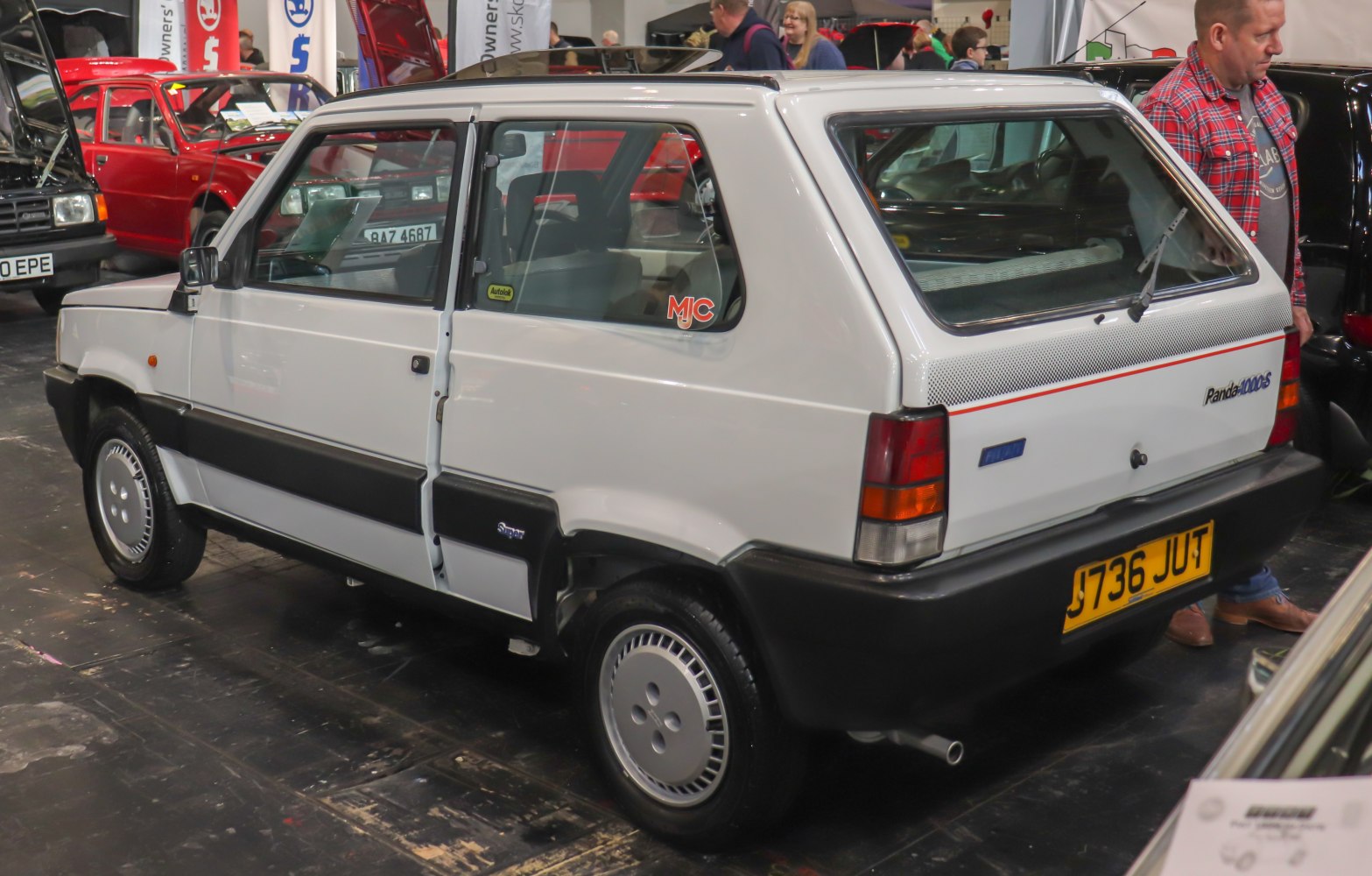 Boxy hatchback rear quarter view with trim and wheel cover detail