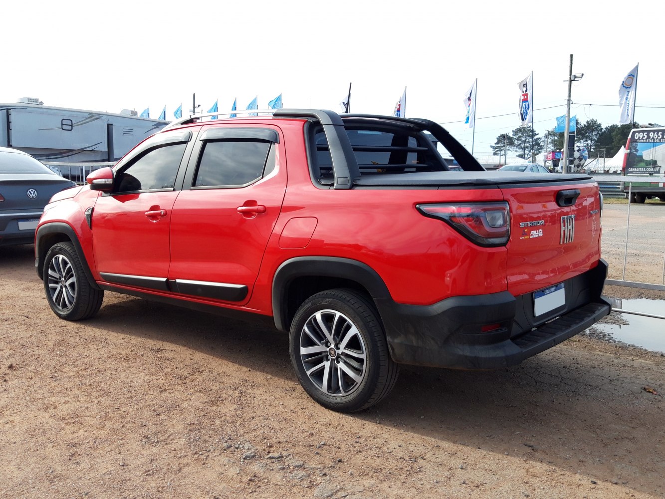 Red double cab pickup with black accents and alloy wheels