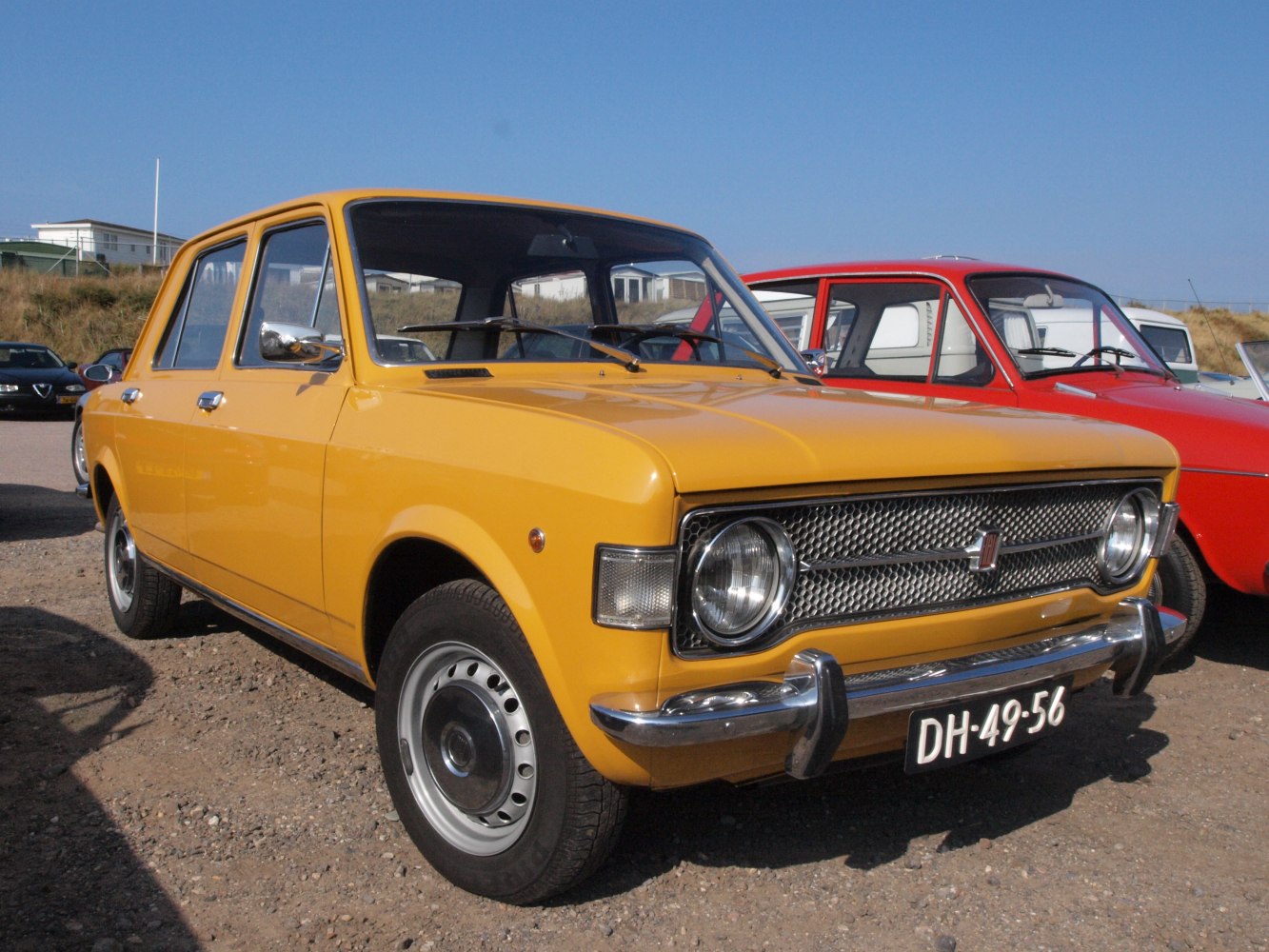 Yellow sedan with round headlights and vintage grille