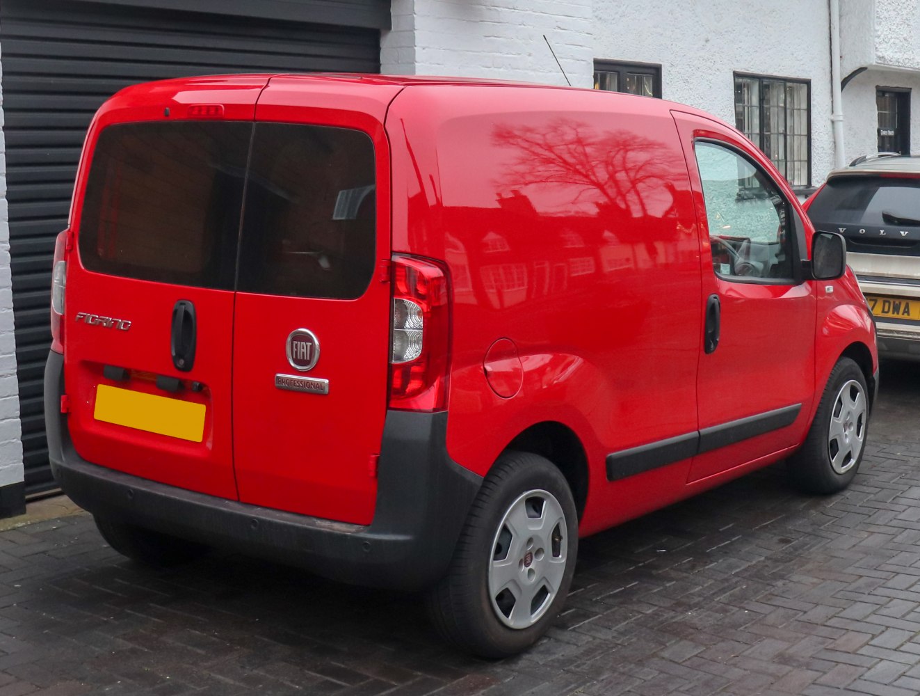 Rear view of red compact cargo van with dual rear doors