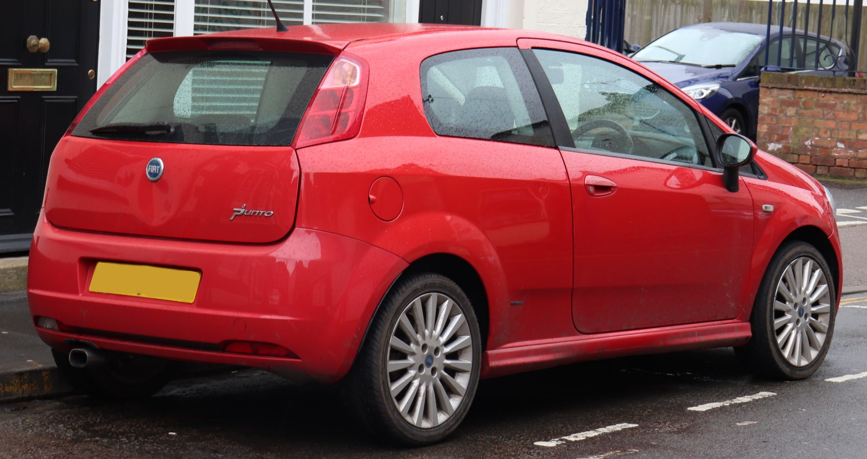 Rear three-quarters view with alloy wheels and rear hatch