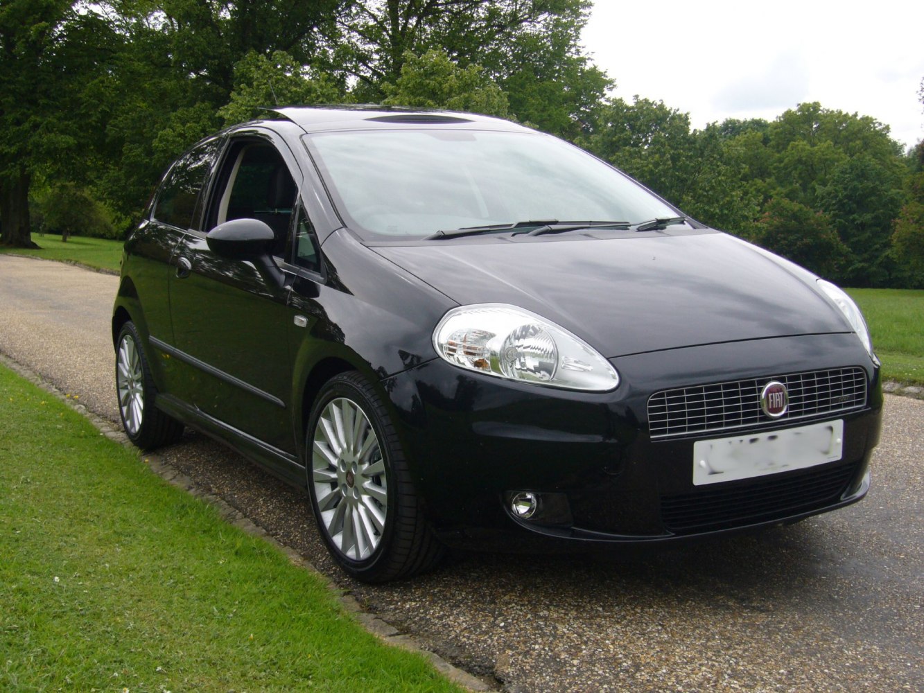 Sleek front and side view with alloy wheels and distinctive headlights
