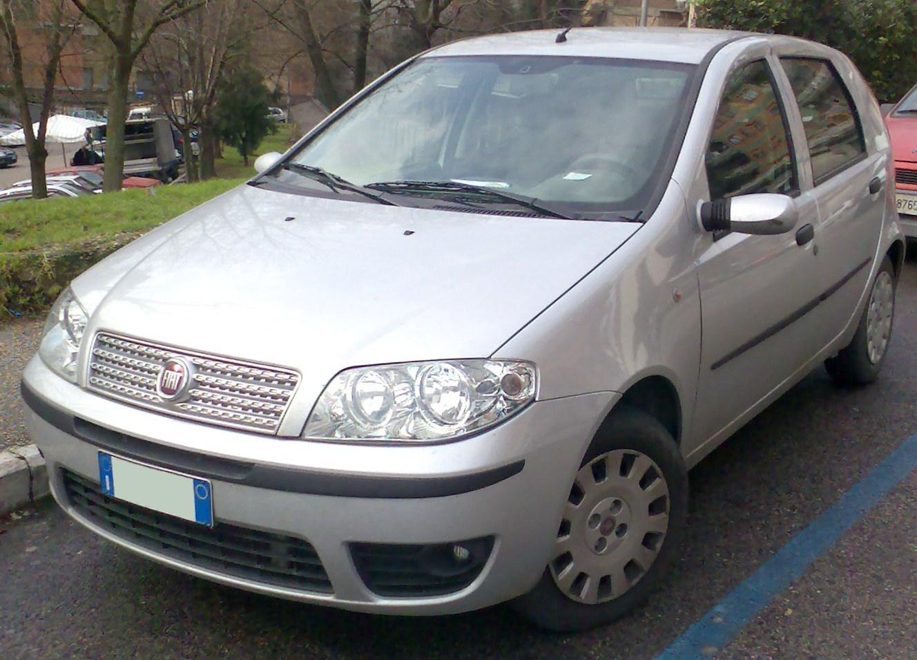 Silver 5-door hatchback with chrome grille and clear headlamps