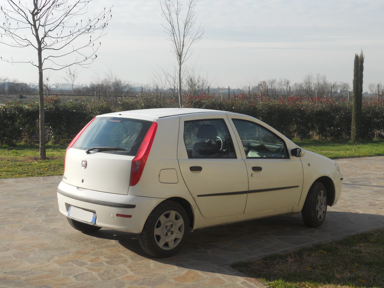Five-door hatchback rear and side view with vertical taillights and rear windshield wiper