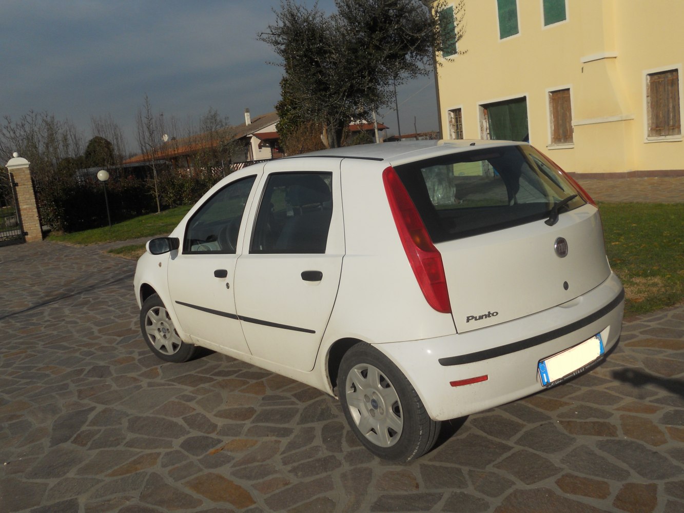 Rear side angle of white 5-door hatchback with vertical taillights