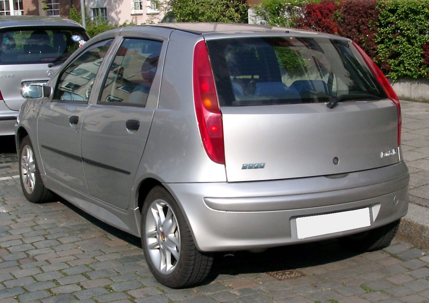 Silver five-door hatchback rear with vertical taillights.